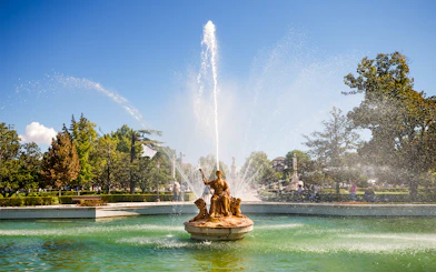 Fountain in the gardens near the Royal Palace of Madrid with water spraying upward.