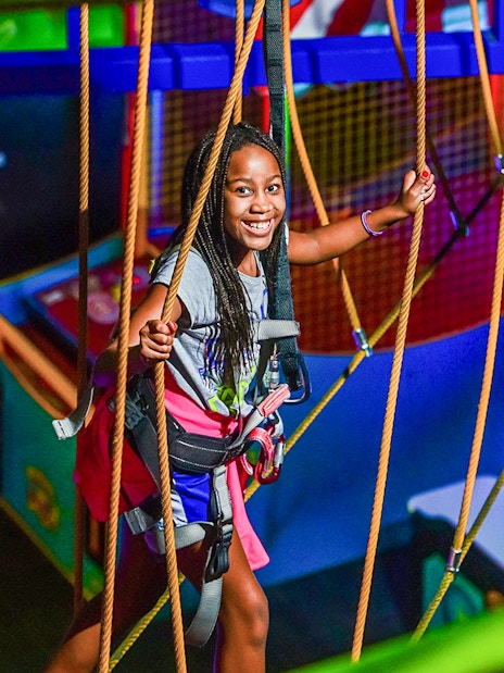 Young girl enjoying a ropes course adventure in Niagara Falls, Canada.