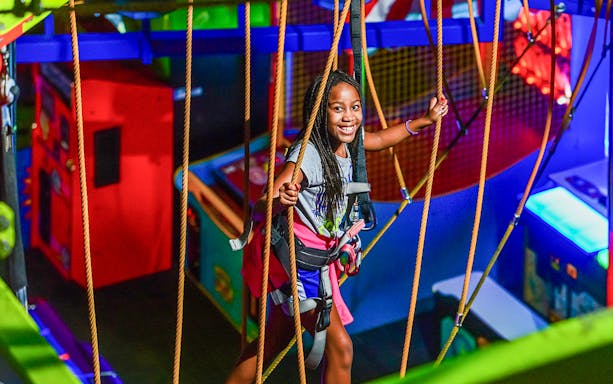 Young girl enjoying a ropes course adventure in Niagara Falls, Canada.