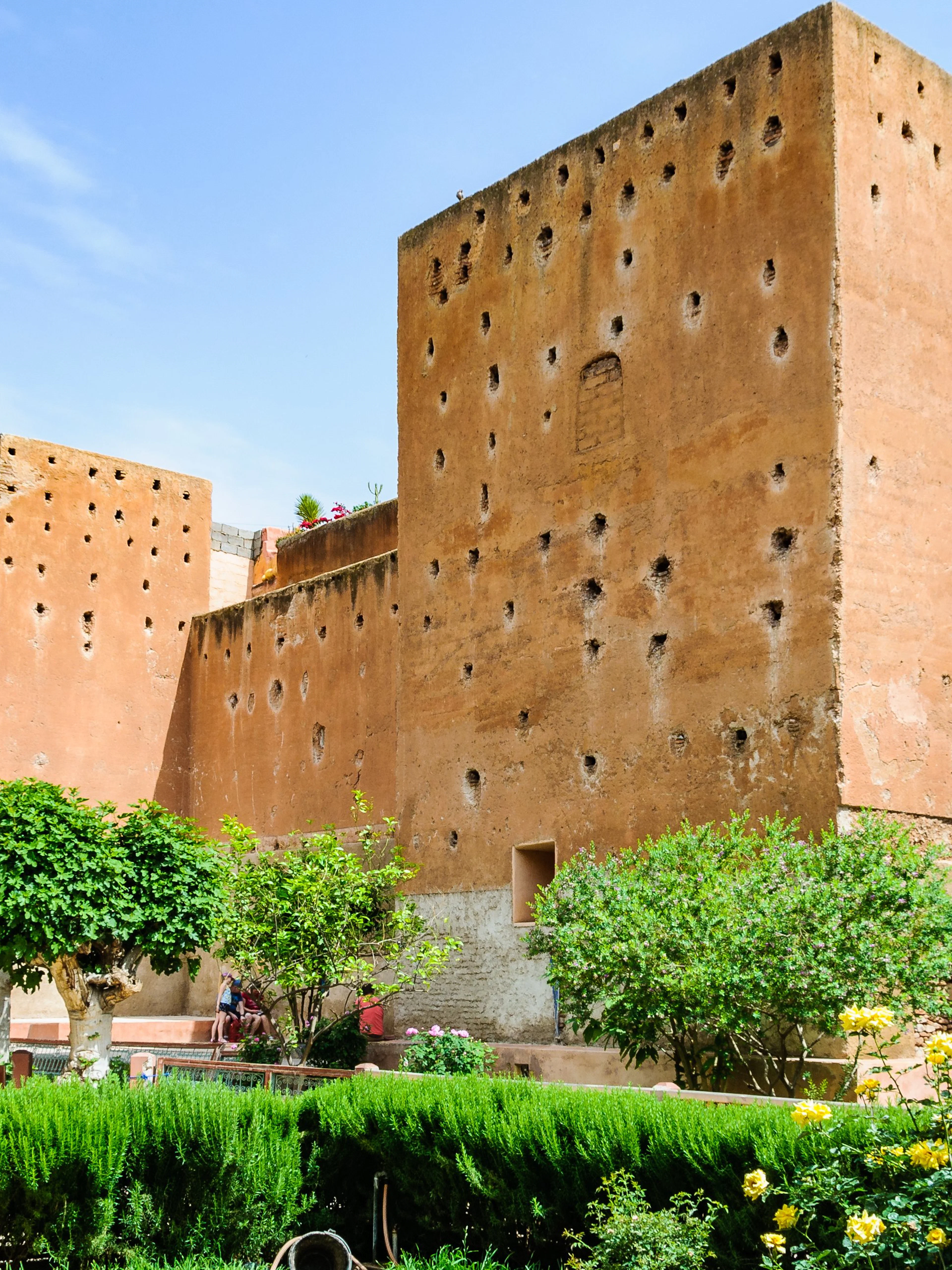 Garden of the Saadian Tombs with historic walls in Marrakech, Morocco.