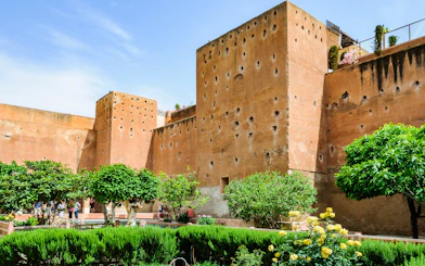 Garden of the Saadian Tombs with historic walls in Marrakech, Morocco.