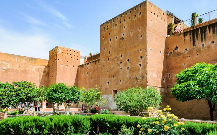 Garden of the Saadian Tombs with historic walls in Marrakech, Morocco.