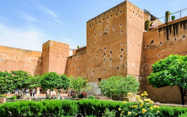 Garden of the Saadian Tombs with historic walls in Marrakech, Morocco.