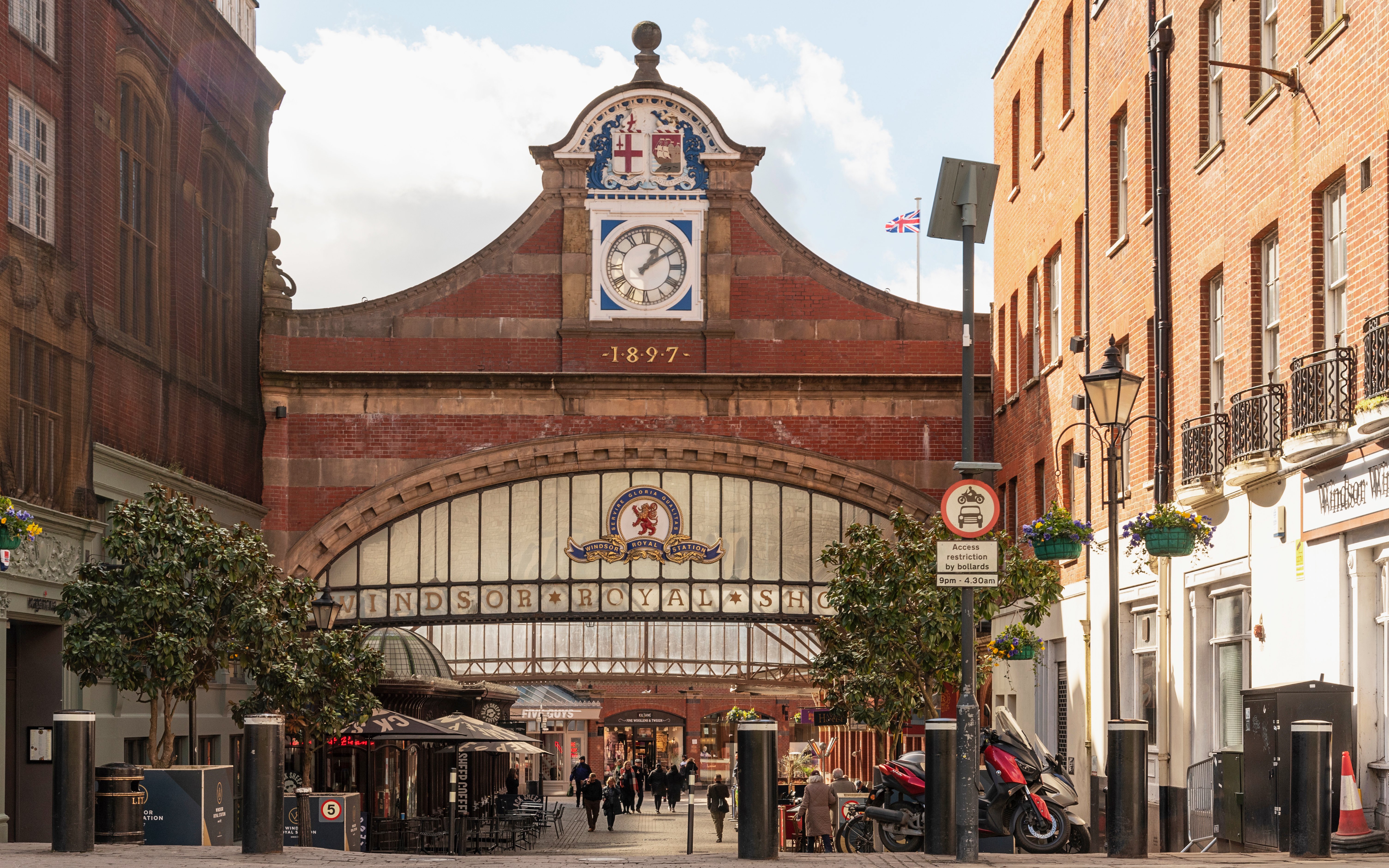 Windsor Castle railway station entrance with clock and shoppers.