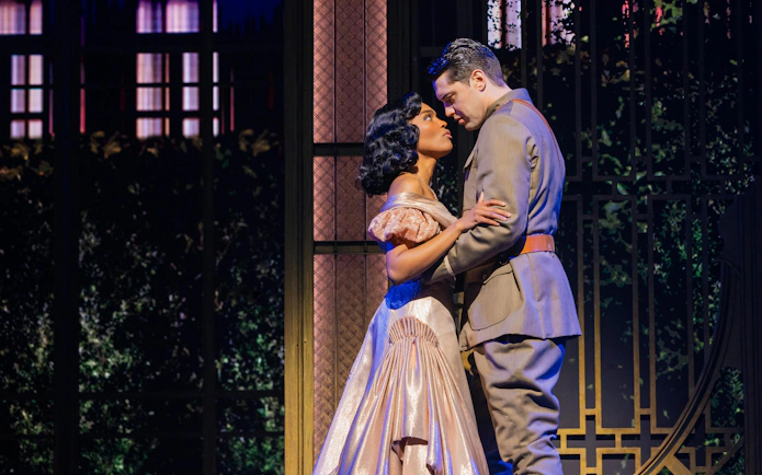 Actors in a romantic scene from The Great Gatsby musical on Broadway stage.