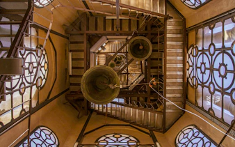Bells and staircases inside the belfry tower at the Metropolitan Cathedral of Santiago, Chile.