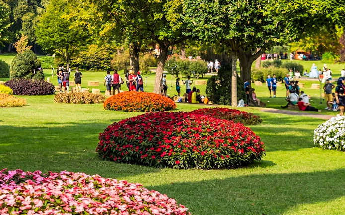 Roses and visitors in Parco Giardino Sigurtà garden, Italy.