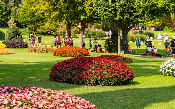 Roses and visitors in Parco Giardino Sigurtà garden, Italy.