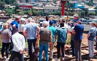 Tour group overlooking Kibera slum during guided walking tour in Nairobi.