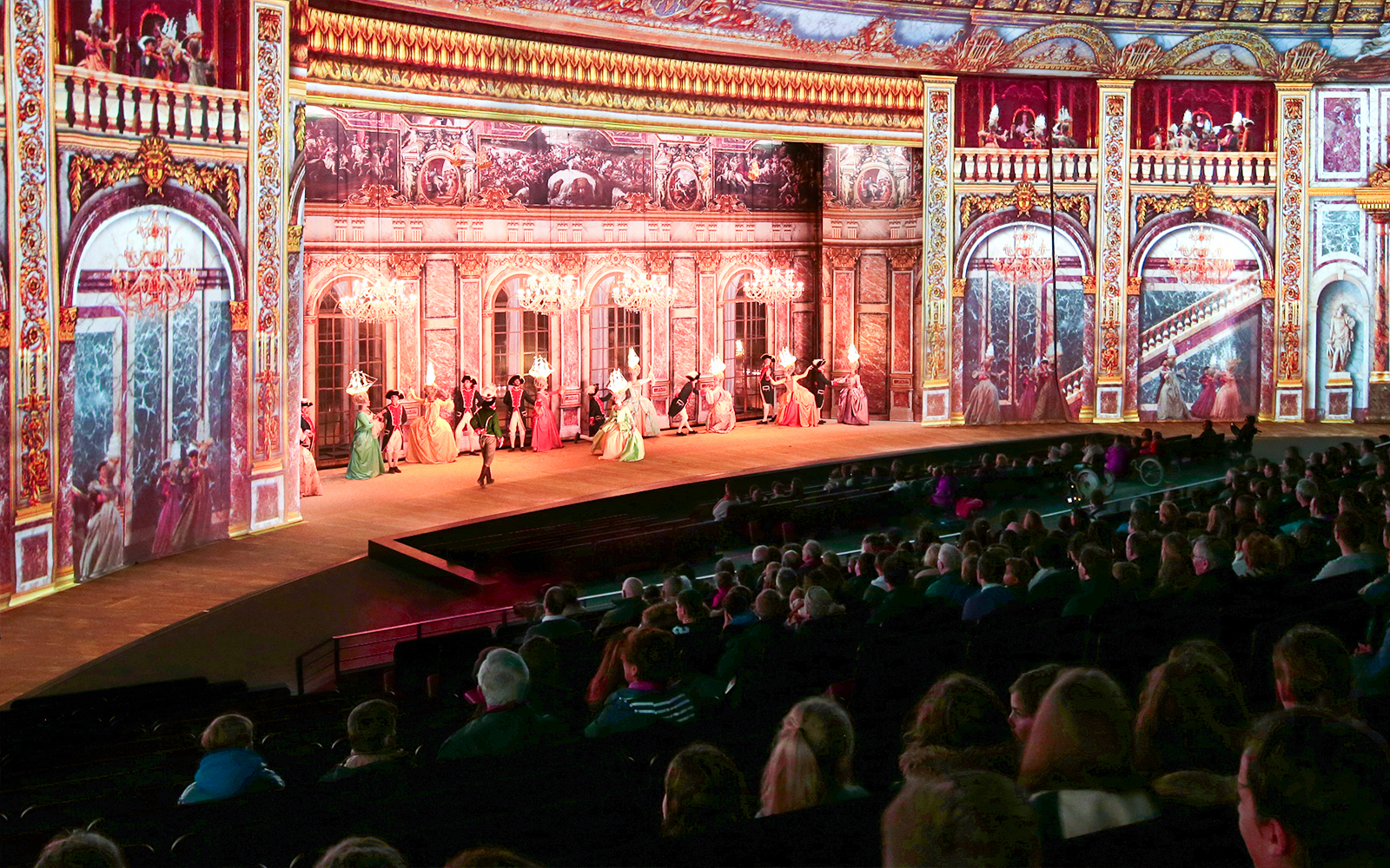 Stage performance at Puy du Fou France with historical costumes and elaborate set design.