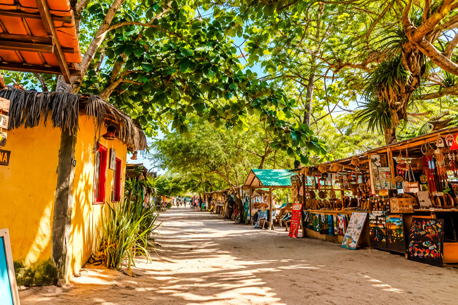 Market stalls under trees in Caraíva, Porto Seguro, Brazil.