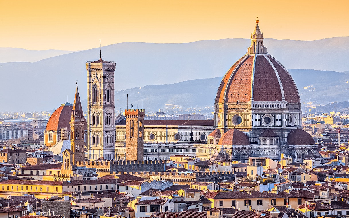 Florence skyline featuring the Duomo and Giotto's Campanile at sunset.