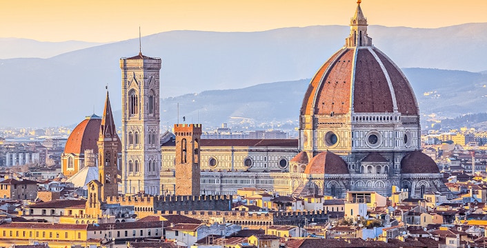 Florence skyline featuring the Duomo and Giotto's Campanile at sunset.