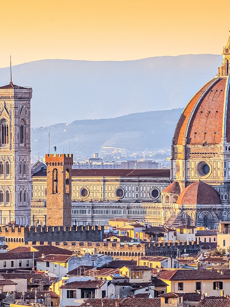Florence skyline featuring the Duomo and Giotto's Campanile at sunset.