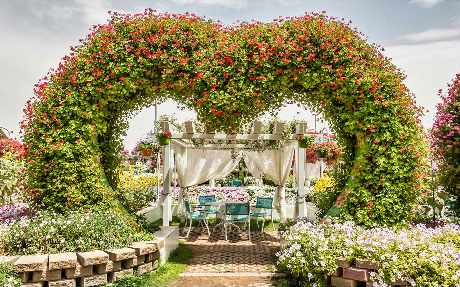 Floral arch and seating area at Dubai Miracle Garden.