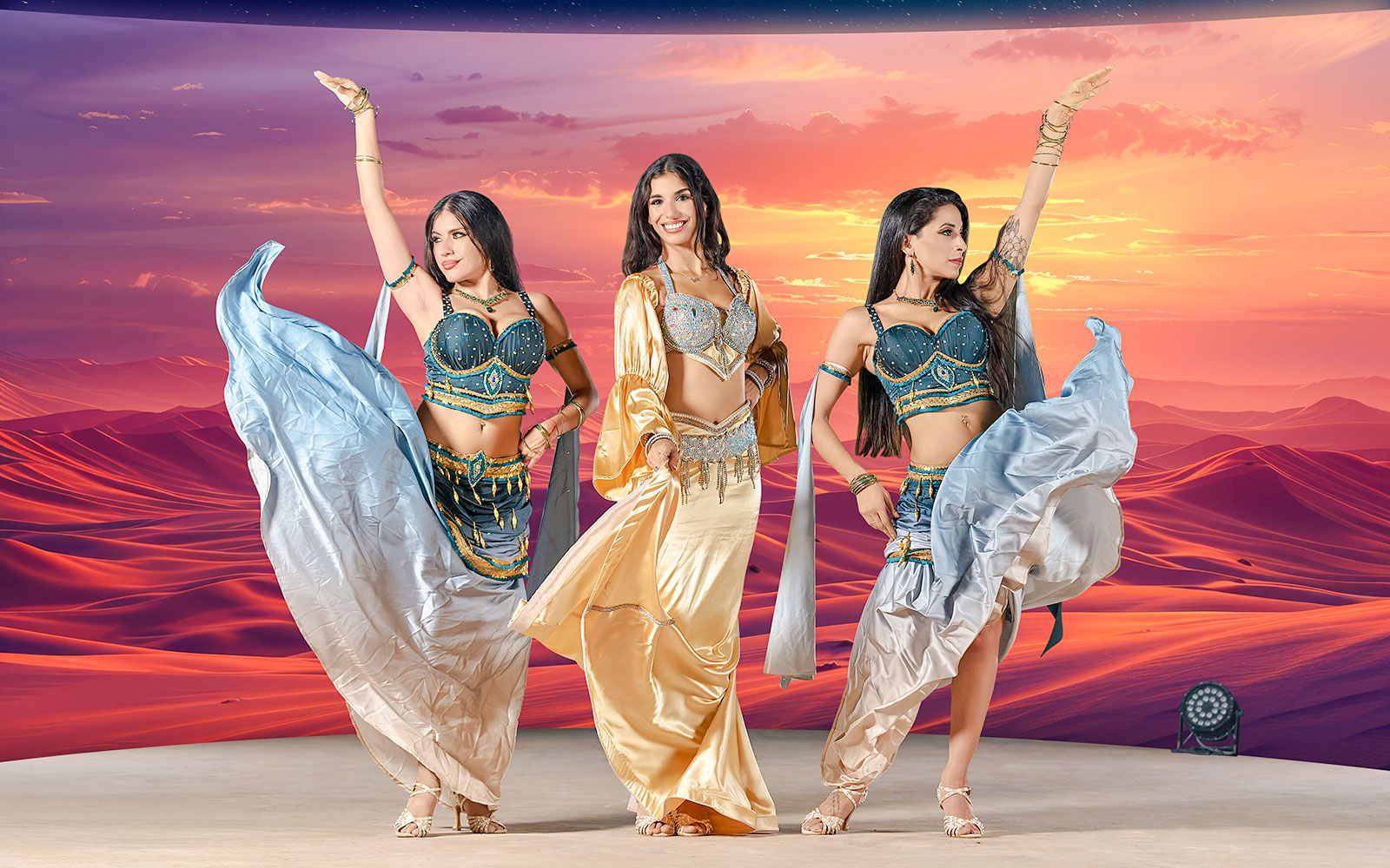 Dancers performing at sunset during live entertainment at Noble Camp Desert Safari.