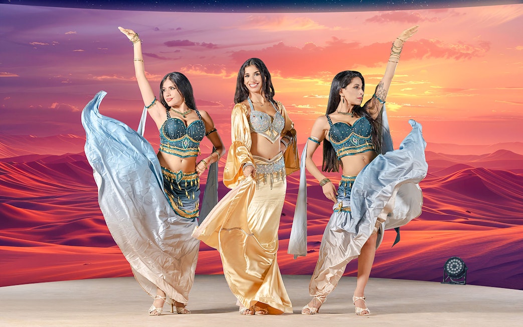 Dancers performing at sunset during live entertainment at Noble Camp Desert Safari.