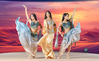 Dancers performing at sunset during live entertainment at Noble Camp Desert Safari.