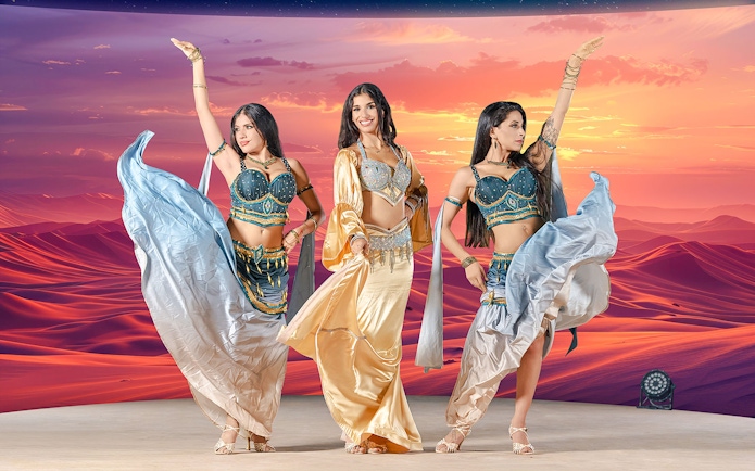 Dancers performing at sunset during live entertainment at Noble Camp Desert Safari.