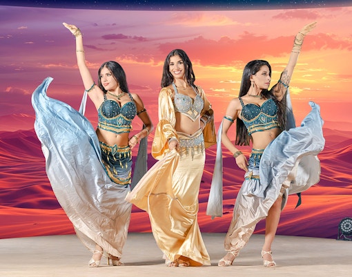 Dancers performing at sunset during live entertainment at Noble Camp Desert Safari.