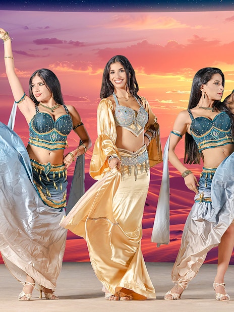 Dancers performing at sunset during live entertainment at Noble Camp Desert Safari.