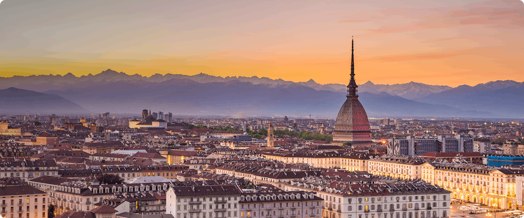Turin skyline with Mole Antonelliana at sunset, Alps in the background.