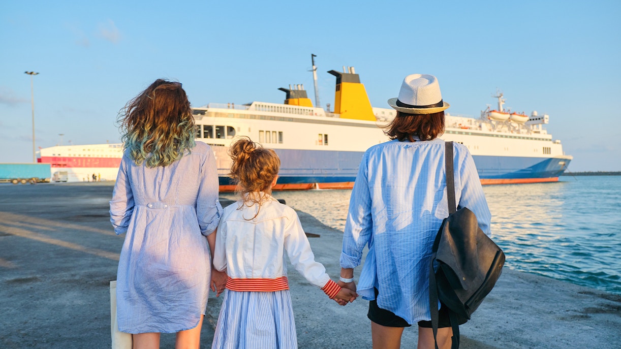 Family boarding ferry at scenic waterfront location