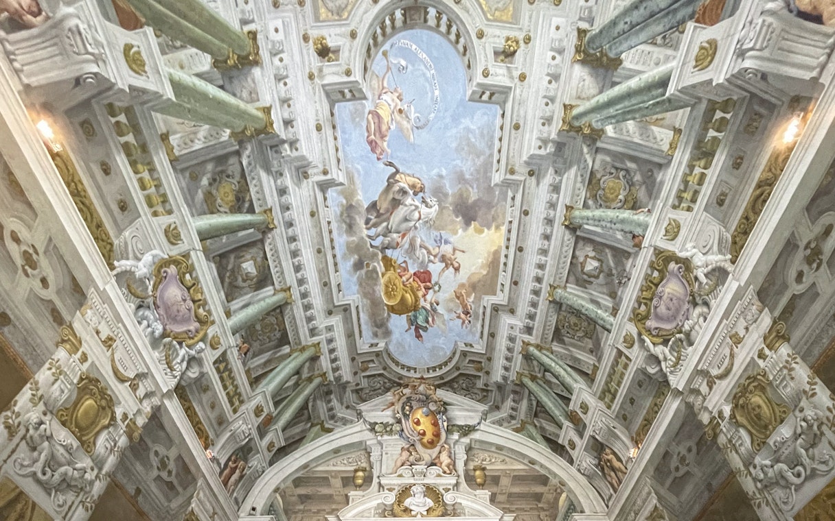 Pitti Palace ceiling frescoes depicting mythological figures in Florence, Italy.