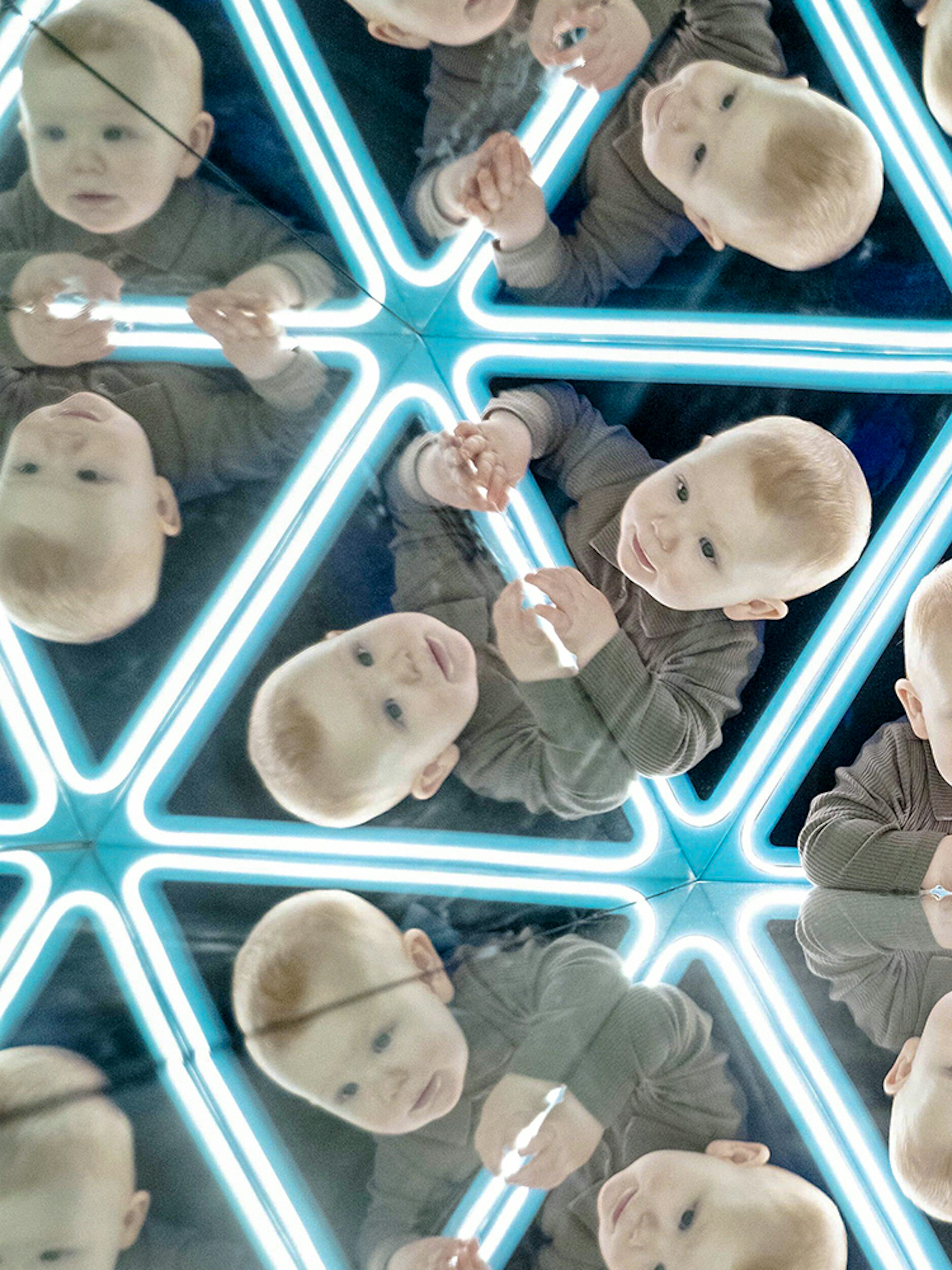 Child exploring mirrored exhibit at the World of Illusions.