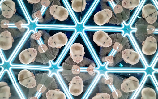 Child exploring mirrored exhibit at the World of Illusions.