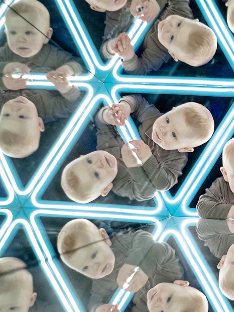 Child exploring mirrored exhibit at the World of Illusions.