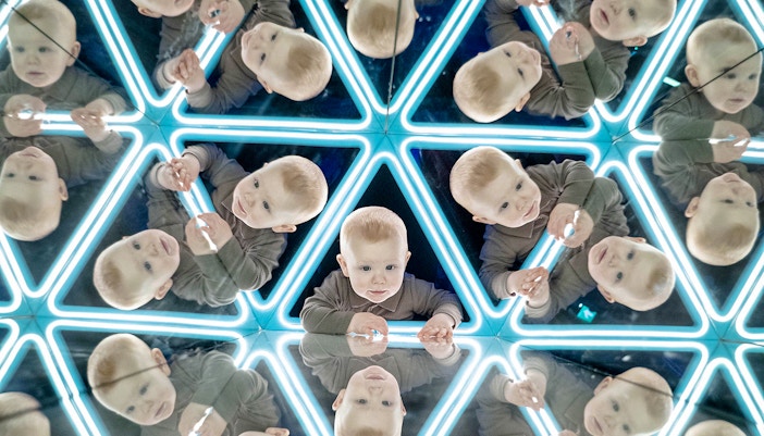 Child exploring mirrored exhibit at the World of Illusions.