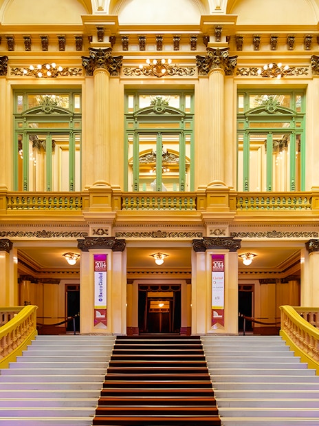 Teatro Colon grand staircase and ornate interior architecture.