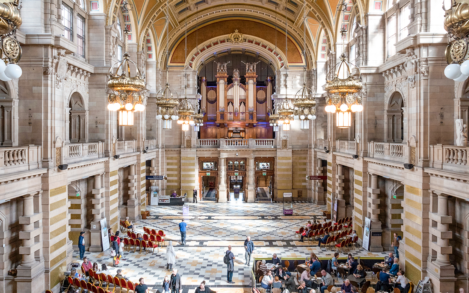 Visitors and artworks inside the Kelvingrove Art Gallery and Museum