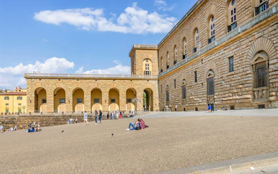 Visitors relaxing outside Palazzo Pitti in Florence, Italy.