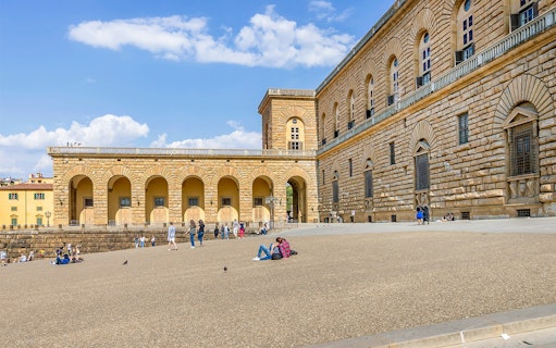 Visitors relaxing outside Palazzo Pitti in Florence, Italy.