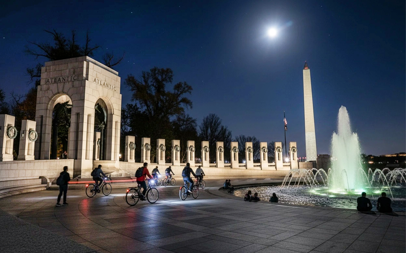 Tourists biking at night near the Washington Memorial in Washington D.C.