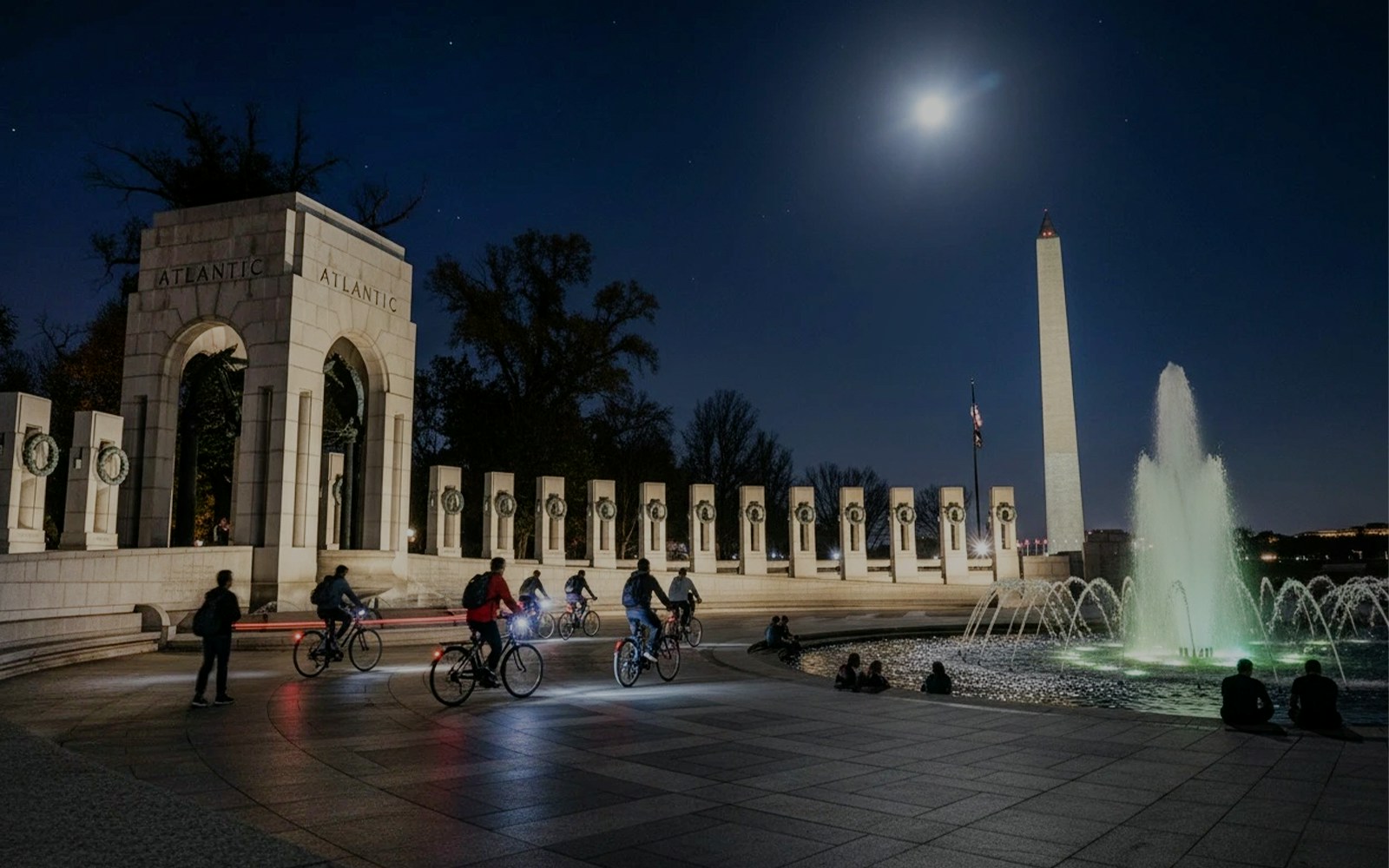 Tourists biking at night near the Washington Memorial in Washington D.C.