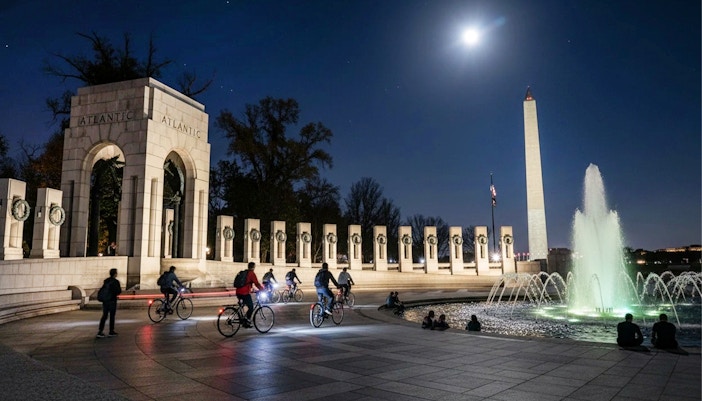Tourists biking at night near the Washington Memorial in Washington D.C.