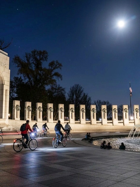 Tourists biking at night near the Washington Memorial in Washington D.C.