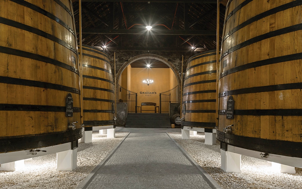 Graham's Port Lodge interior with large wooden barrels, Portugal.