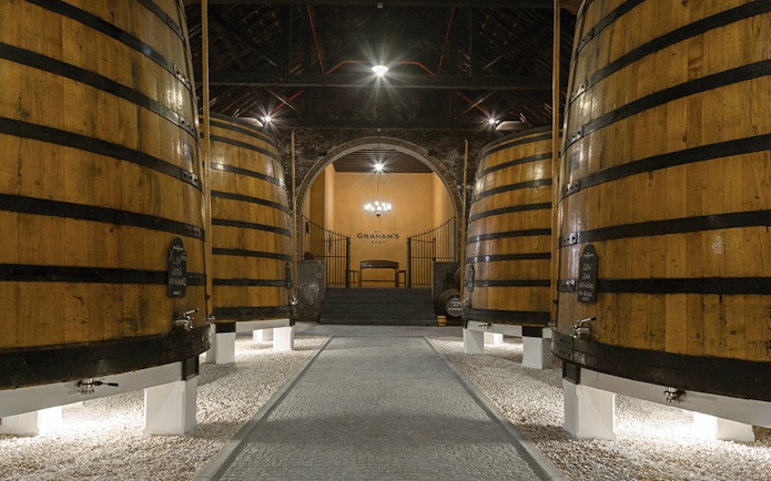 Graham's Port Lodge interior with large wooden barrels, Portugal.