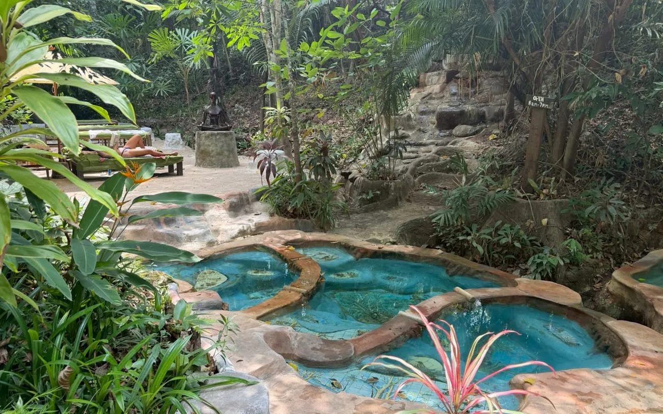 Hot spring spa surrounded by lush greenery in Krabi Jungle Tour, Thailand.