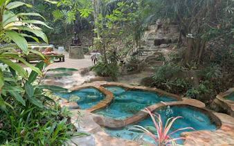 Hot spring spa surrounded by lush greenery in Krabi Jungle Tour, Thailand.