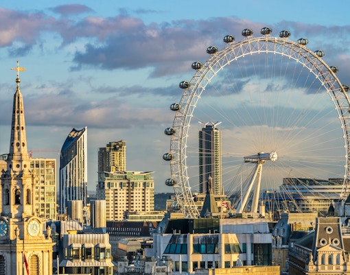 London Eye and city skyline at sunset.