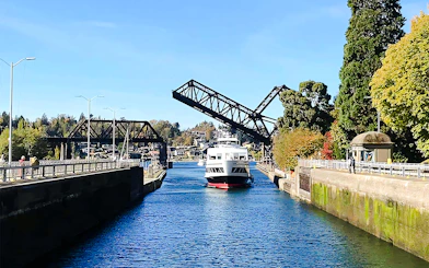 Boat passing through a raised drawbridge on a harbor cruise.