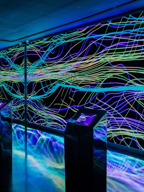 Interactive digital art installation at Moco Museum Barcelona with vibrant neon lines.