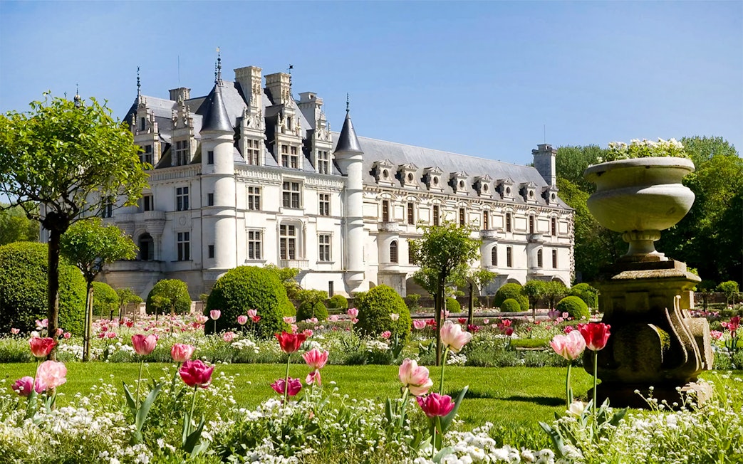 Château de Chenonceau with vibrant gardens, part of Loire Valley tour from Paris.