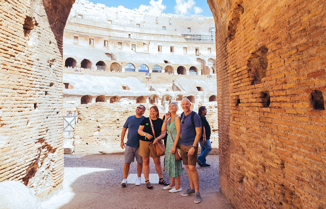 Tourists on the Colosseum arena floor during a semi-private tour with Gladiator’s Entrance.