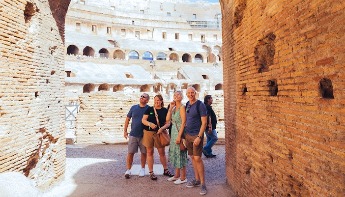 Tourists on the Colosseum arena floor during a semi-private tour with Gladiator’s Entrance.